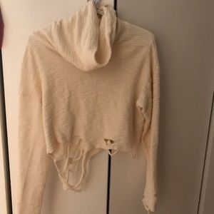 Distressed cream sweater